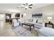 Open concept living room with large windows and access to the kitchen and dining area at 10374 Echo Dock Loop, San Antonio, FL 33576