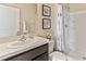 Clean bathroom with dark vanity, a shower/tub combo, and a white toilet at 10558 Dusty Boot Rd, Land O Lakes, FL 34638