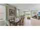 Elegant dining room with a dark wood table and chairs, and green patterned curtains at 10558 Dusty Boot Rd, Land O Lakes, FL 34638