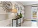 Bright entryway with striped walls, decorative mirrors, and a console table at 10558 Dusty Boot Rd, Land O Lakes, FL 34638