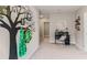 Upstairs hallway featuring a tree wall decal, a desk, and a chair at 10558 Dusty Boot Rd, Land O Lakes, FL 34638