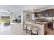 Open kitchen boasting granite countertops, dark cabinetry, and stainless steel appliances at 10558 Dusty Boot Rd, Land O Lakes, FL 34638