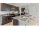 Modern kitchen with dark wood cabinets, granite countertops, and stainless steel appliances at 10558 Dusty Boot Rd, Land O Lakes, FL 34638