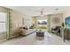 Relaxing living area featuring a neutral color scheme, a comfy sofa, and access to a patio at 10558 Dusty Boot Rd, Land O Lakes, FL 34638
