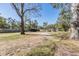 Large backyard with mature trees and a clearing at 14045 21St St, Dade City, FL 33525