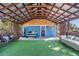 Covered patio with artificial turf, seating, and wooden beams at 14045 21St St, Dade City, FL 33525