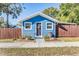 Charming blue house with wooden fence and landscaping at 14045 21St St, Dade City, FL 33525
