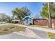 Blue house with wooden fence and side yard view at 14045 21St St, Dade City, FL 33525