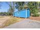 Blue storage shed with a single window at 14045 21St St, Dade City, FL 33525