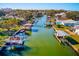 Drone view of waterfront community with boats and lush foliage at 1575 Brookside Blvd, Largo, FL 33770