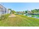 Waterfront backyard with grassy area and patio seating at 1575 Brookside Blvd, Largo, FL 33770