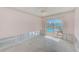 Bedroom overlooking the pool through sliding glass doors, ready for renovation at 1575 Brookside Blvd, Largo, FL 33770