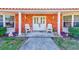 Brick home with white porch chairs and double front doors at 1575 Brookside Blvd, Largo, FL 33770