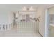 Kitchen area with glass block detailing, white cabinets, and a view to the outside at 1575 Brookside Blvd, Largo, FL 33770