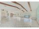 Open concept living room with tile flooring, an aquarium, and views of the pool and kitchen at 1575 Brookside Blvd, Largo, FL 33770