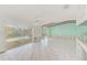 Bright living room with tile floors, beamed ceilings, and sliding glass doors leading to the pool area at 1575 Brookside Blvd, Largo, FL 33770