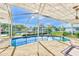 Enclosed pool area with canal view and patio furniture at 1575 Brookside Blvd, Largo, FL 33770