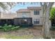 Back exterior view showing a two story home and patio at 17546 Fairmeadow Dr, Tampa, FL 33647