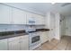White kitchen with granite countertops and microwave at 17546 Fairmeadow Dr, Tampa, FL 33647
