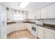 Bright kitchen featuring white cabinets and granite countertops at 17546 Fairmeadow Dr, Tampa, FL 33647