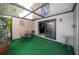 Cozy screened patio with artificial turf and a table at 17546 Fairmeadow Dr, Tampa, FL 33647