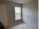 Bright bedroom with a large window, neutral walls, and carpeting at 1799 N Highland Ave # 44, Clearwater, FL 33755