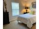 Bright bedroom with large window, neutral decor, and ample lighting at 1799 N Highland Ave # 44, Clearwater, FL 33755