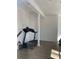 Small exercise room with treadmill and laminate flooring at 1799 N Highland Ave # 44, Clearwater, FL 33755