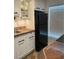 Black refrigerator and updated countertops feature in this stylish kitchen at 1799 N Highland Ave # 44, Clearwater, FL 33755