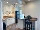 Modern kitchen with white cabinets, breakfast bar, and granite countertops at 1799 N Highland Ave # 44, Clearwater, FL 33755