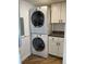 Stackable washer and dryer in a well-lit laundry closet at 1799 N Highland Ave # 44, Clearwater, FL 33755