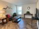 Bright living room features herringbone floors, comfy seating, and large windows at 1799 N Highland Ave # 44, Clearwater, FL 33755