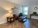 Bright living room features herringbone floors, comfy seating, and large windows at 1799 N Highland Ave # 44, Clearwater, FL 33755
