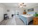 Light blue bedroom with wood dresser and sliding glass door to sunroom at 2043 Denmark St # 65, Clearwater, FL 33763