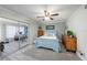Light blue bedroom with wood dresser and sliding glass door to sunroom at 2043 Denmark St # 65, Clearwater, FL 33763