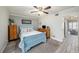 Light blue bedroom with wood dresser and view of another room at 2043 Denmark St # 65, Clearwater, FL 33763