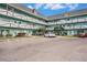 Exterior of a light green building with parking at 2043 Denmark St # 65, Clearwater, FL 33763