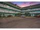Two-story building with parking lot, showcasing a tranquil evening scene at 2043 Denmark St # 65, Clearwater, FL 33763