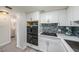 Modern kitchen with white cabinets, updated appliances, and tile backsplash at 2043 Denmark St # 65, Clearwater, FL 33763