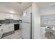 Modern kitchen with white cabinets, updated appliances, and tile backsplash at 2043 Denmark St # 65, Clearwater, FL 33763