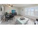 Living room with dining area, TV, and access to patio at 2043 Denmark St # 65, Clearwater, FL 33763