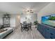 Living room with dining area, TV, and access to patio at 2043 Denmark St # 65, Clearwater, FL 33763