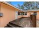Steps lead up to a wooden back deck, perfect for outdoor relaxation at 2201 Park N St, St Petersburg, FL 33710