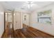 Bedroom with hardwood floors, mirrored closet doors, and a window with blinds at 2201 Park N St, St Petersburg, FL 33710