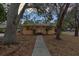 Cute ranch home with walkway, mature trees, and a well-manicured lawn at 2201 Park N St, St Petersburg, FL 33710