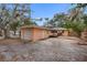 Rear view of a house showcasing a detached garage and a sizable backyard at 2201 Park N St, St Petersburg, FL 33710
