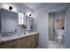 Modern bathroom featuring double sinks, marble countertops, and a shower at 2550 1St N Ave, St Petersburg, FL 33713