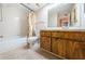 Clean bathroom with shower/tub and wood cabinets at 2587 Countryside Blvd # 6303, Clearwater, FL 33761