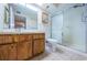 Bathroom with wood cabinets, shower, and toilet at 2587 Countryside Blvd # 6303, Clearwater, FL 33761