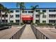 Condo building entrance with red awning and gated access at 2587 Countryside Blvd # 6303, Clearwater, FL 33761